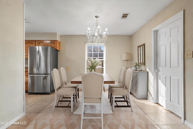 tiled dining area with a notable chandelier