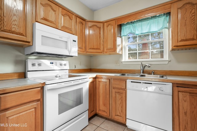 kitchen with sink, white appliances, and light tile patterned floors