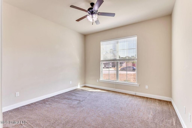 carpeted spare room with ceiling fan