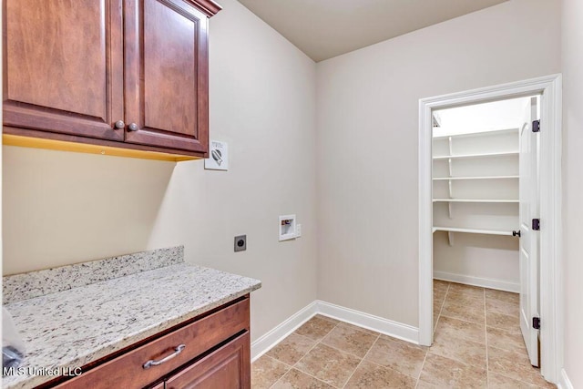 laundry room with hookup for an electric dryer, hookup for a washing machine, and cabinets