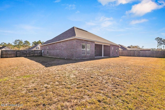 rear view of house with a lawn