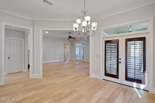 foyer entrance featuring french doors, ornamental molding, light wood-type flooring, and ceiling fan with notable chandelier