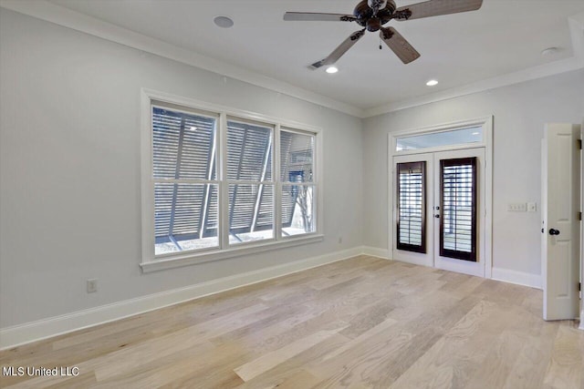 empty room featuring light hardwood / wood-style flooring, french doors, ceiling fan, and crown molding