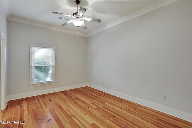 empty room featuring ceiling fan, ornamental molding, and light wood-type flooring