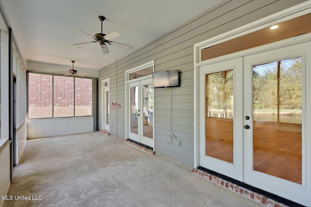 unfurnished sunroom with french doors and ceiling fan