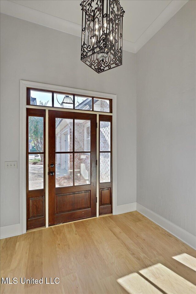 111 Southampton Cir, Madison, MS 39110 - entryway featuring a chandelier, baseboards, wood finished floors, and ornamental molding