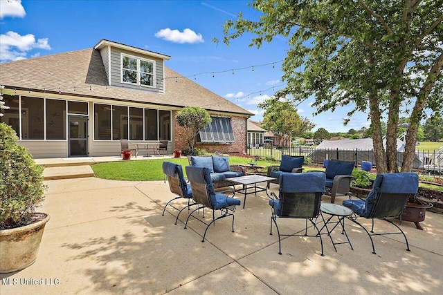 view of patio / terrace featuring outdoor lounge area and a sunroom