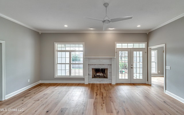 unfurnished living room featuring wood finished floors, french doors, and ornamental molding