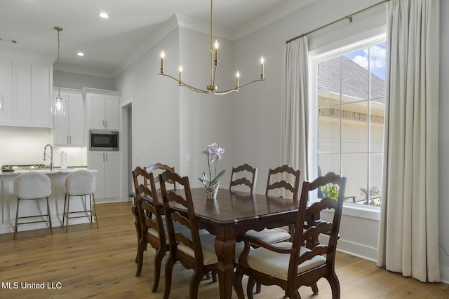 168 Shore View Dr, Madison, MS 39110 - dining space with light wood-style flooring, a chandelier, crown molding, and recessed lighting