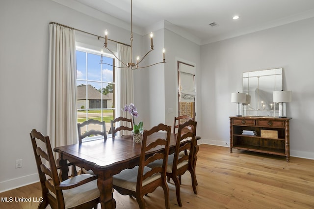 168 Shore View Dr, Madison, MS 39110 - dining area with light wood-style flooring, a chandelier, and crown molding