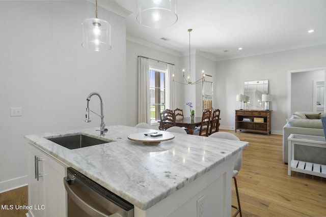168 Shore View Dr, Madison, MS 39110 - kitchen with stainless steel dishwasher, a kitchen bar, white cabinetry, light wood-style floors, and hanging light fixtures