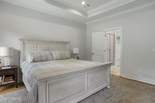 168 Shore View Dr, Madison, MS 39110 - bedroom featuring wood finished floors, crown molding, connected bathroom, and a tray ceiling