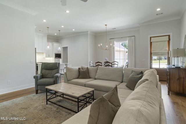 168 Shore View Dr, Madison, MS 39110 - living area featuring a chandelier, wood finished floors, recessed lighting, ceiling fan, and crown molding