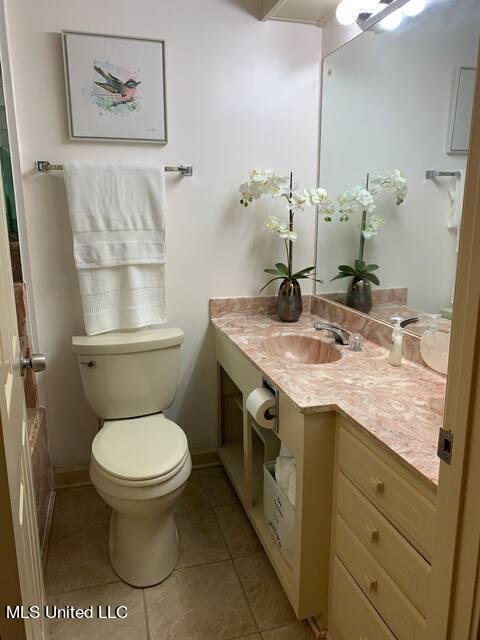 bathroom featuring tile patterned floors, vanity, and toilet