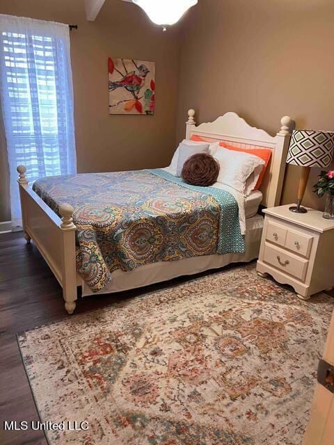 bedroom with dark wood-type flooring