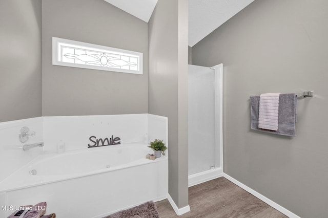 10326 Amanda Dr, Olive Branch, MS 38654 - full bathroom with wood finished floors, a bath, and lofted ceiling