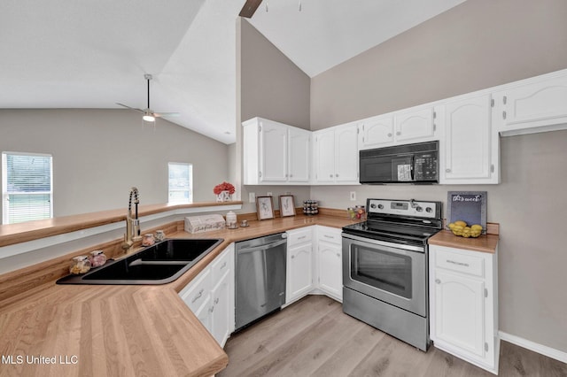 10326 Amanda Dr, Olive Branch, MS 38654 - kitchen with stainless steel appliances, a ceiling fan, vaulted ceiling, and white cabinetry