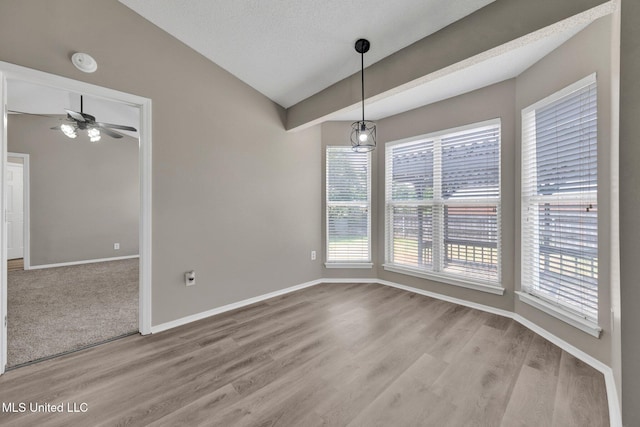 10326 Amanda Dr, Olive Branch, MS 38654 - unfurnished dining area with healthy amount of natural light, lofted ceiling, light wood-style floors, and ceiling fan
