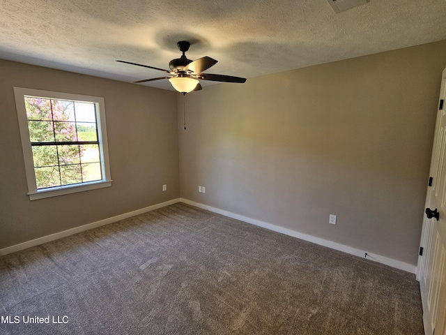 empty room with carpet flooring, ceiling fan, and a textured ceiling