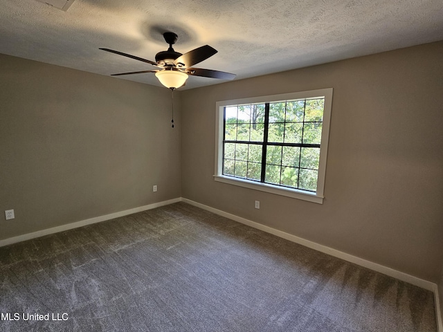 carpeted empty room featuring ceiling fan and a textured ceiling