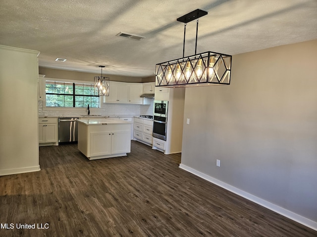 kitchen with dishwasher, a center island, white cabinets, hanging light fixtures, and dark hardwood / wood-style floors