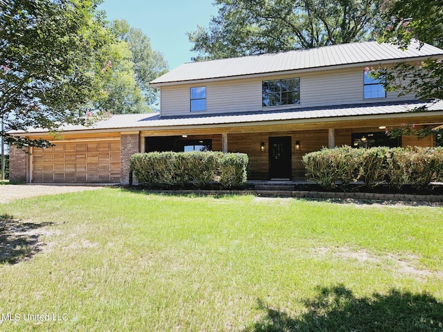 view of front of home with a front lawn and a garage