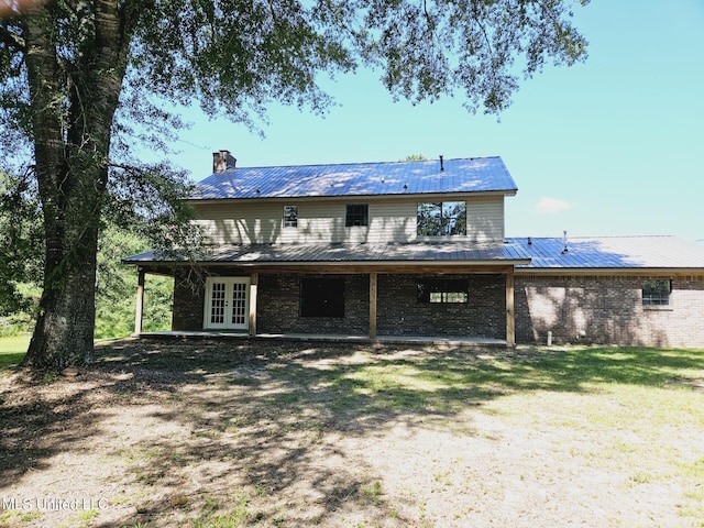 back of house featuring french doors and a yard