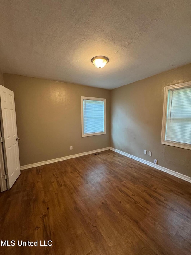 3115 Shirley Dr, Jackson, MS 39212 - spare room featuring a textured ceiling and dark wood finished floors