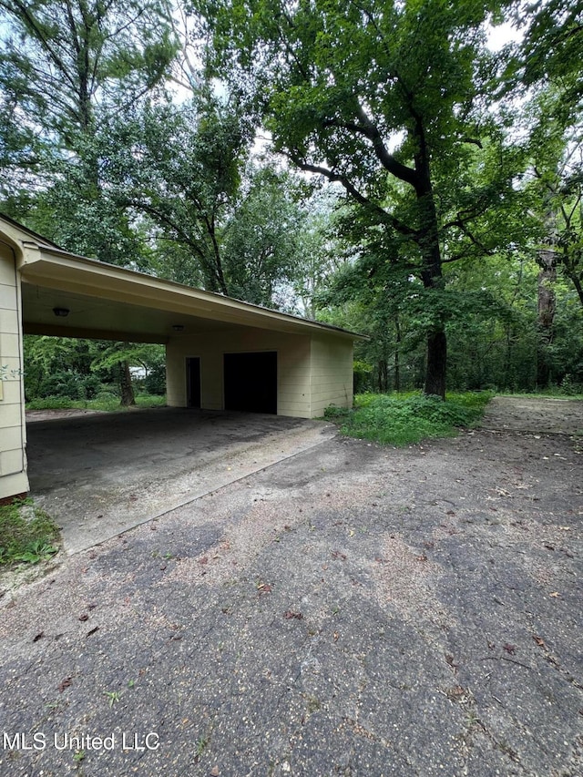 3115 Shirley Dr, Jackson, MS 39212 - garage with an attached carport and asphalt driveway