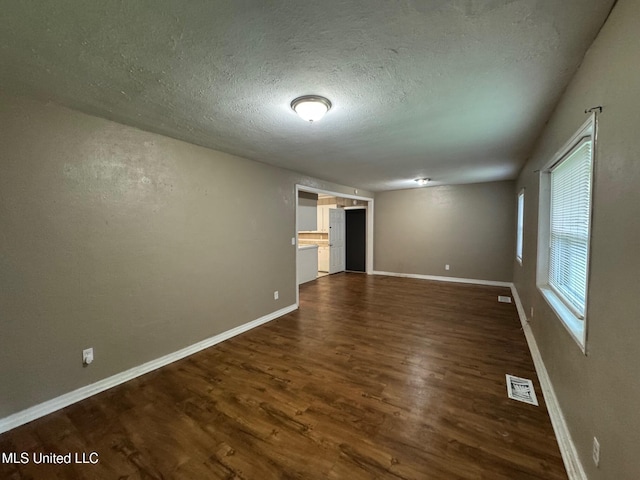 3115 Shirley Dr, Jackson, MS 39212 - empty room with dark wood finished floors and a textured ceiling