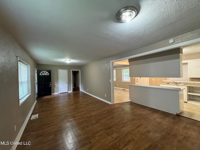 3115 Shirley Dr, Jackson, MS 39212 - unfurnished living room with dark wood-style floors and a textured ceiling