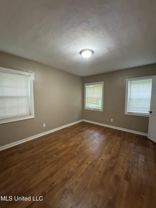 3115 Shirley Dr, Jackson, MS 39212 - unfurnished room with wood finished floors, healthy amount of natural light, and a textured ceiling
