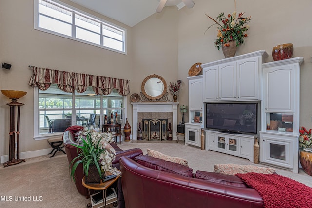 1000 Cedar Hill Rd, Madison, MS 39110 - living room with light colored carpet, high vaulted ceiling, a tiled fireplace, baseboards, and plenty of natural light