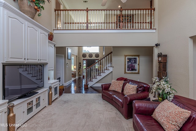 1000 Cedar Hill Rd, Madison, MS 39110 - living room with stairway, a towering ceiling, light wood-style floors, and a ceiling fan