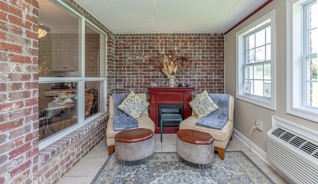 1000 Cedar Hill Rd, Madison, MS 39110 - living area featuring tile patterned flooring, a wall mounted AC, brick wall, baseboards, and a textured ceiling