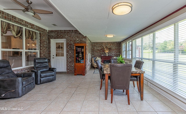 1000 Cedar Hill Rd, Madison, MS 39110 - sunroom with brick wall, ornamental molding, a wood stove, tile patterned floors, and a textured ceiling