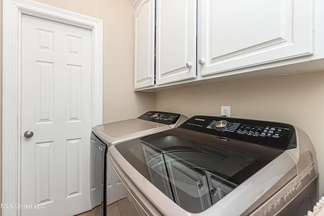 1000 Cedar Hill Rd, Madison, MS 39110 - laundry room featuring washer and dryer, cabinet space, and light tile patterned flooring