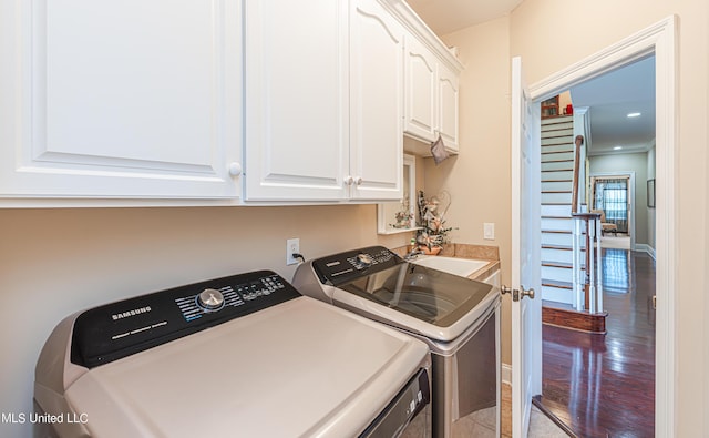 1000 Cedar Hill Rd, Madison, MS 39110 - washroom with washing machine and dryer, cabinet space, and wood finished floors