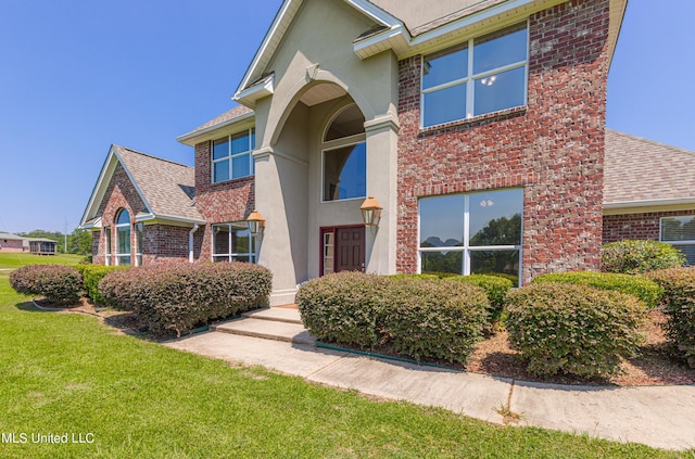 1000 Cedar Hill Rd, Madison, MS 39110 - view of front of home featuring roof with shingles, brick siding, a front lawn, and stucco siding