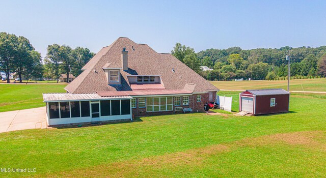 1000 Cedar Hill Rd, Madison, MS 39110 - rear view of property featuring a sunroom, an outdoor structure, a lawn, and a storage shed