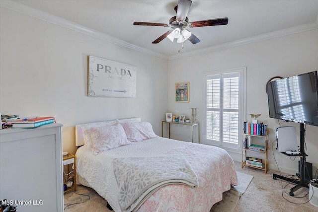 carpeted bedroom with ceiling fan and ornamental molding