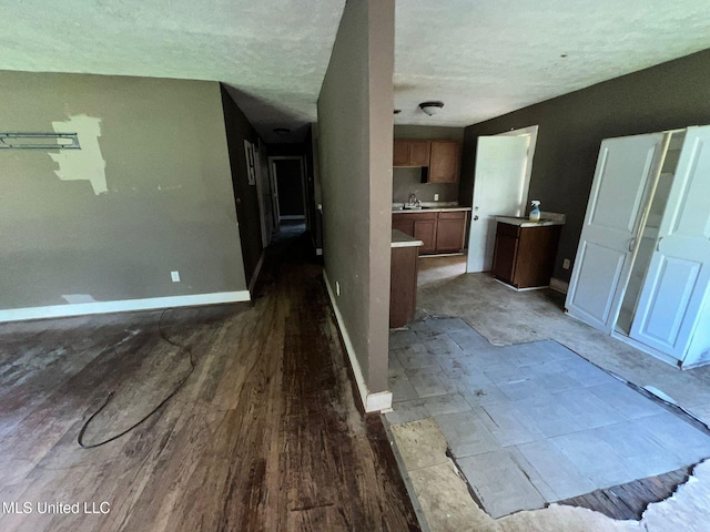 4515 25th St, Meridian, MS 39307 - interior space with baseboards, wood finished floors, a textured ceiling, and a sink