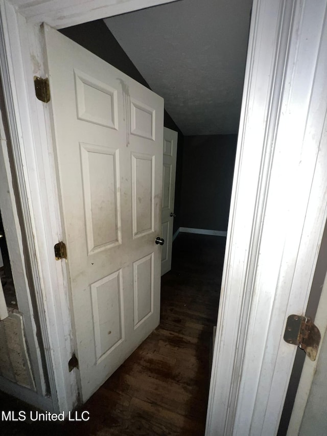 4515 25th St, Meridian, MS 39307 - hallway featuring lofted ceiling and dark wood-type flooring