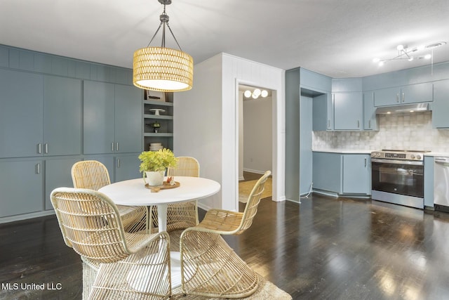 dining space with dark wood finished floors, baseboards, and built in shelves