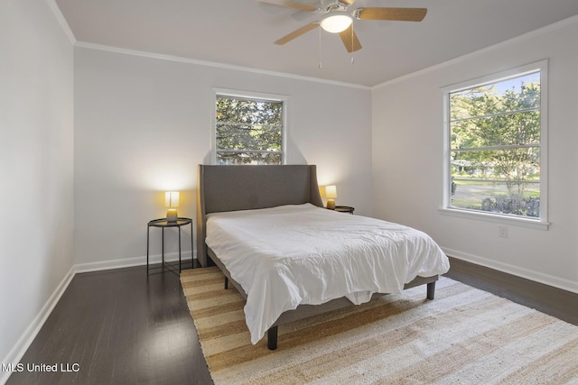 bedroom with wood finished floors, baseboards, ornamental molding, and ceiling fan