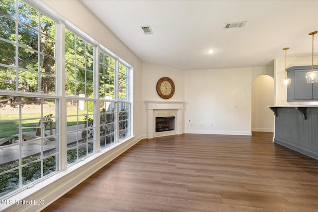 unfurnished living room featuring dark hardwood / wood-style floors