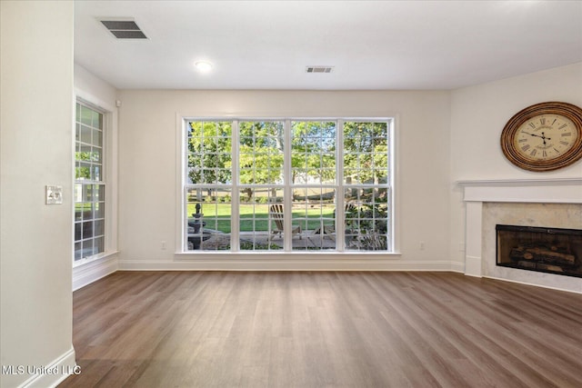 unfurnished living room featuring hardwood / wood-style floors and a fireplace