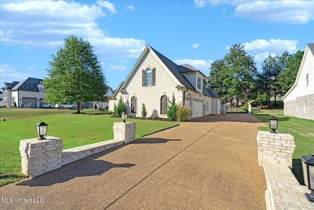 view of front of home with a garage and a front yard