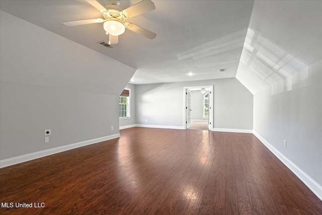 bonus room with ceiling fan, dark hardwood / wood-style floors, and vaulted ceiling