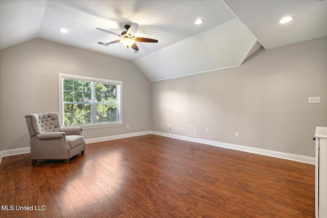 unfurnished room with dark hardwood / wood-style flooring, vaulted ceiling, and ceiling fan